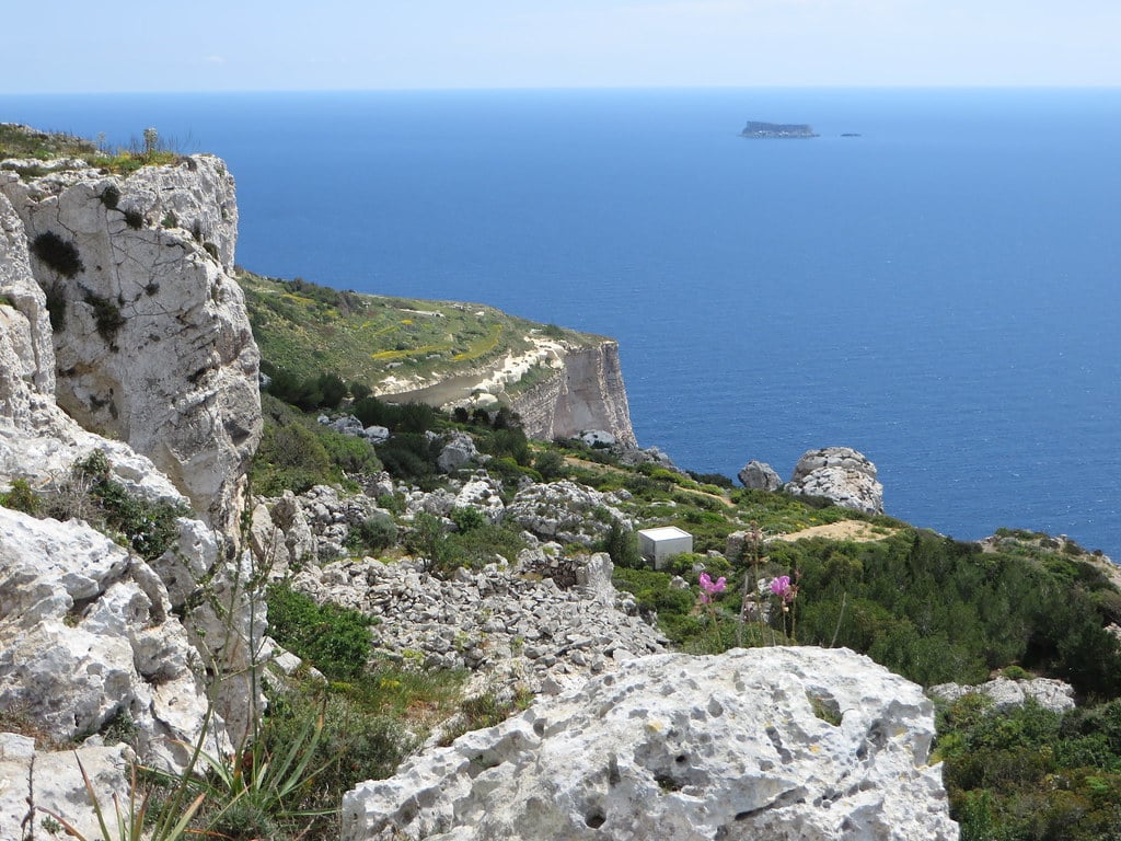 Cliffside coastal view of Malta's countryside and sea in summer light